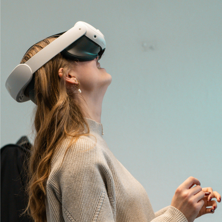 Person wearing a futuristic meta quest 3 AR headset enjoying an installation 