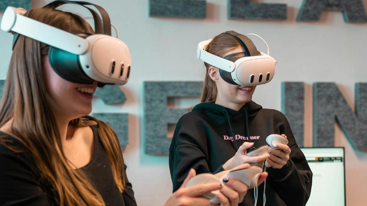 Two people learning in VR headsets in  class room